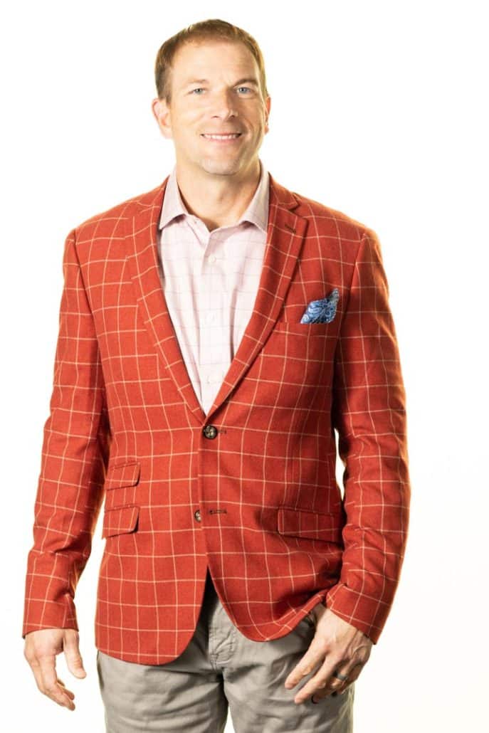 Dr. Bell red suit standing